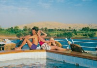 A couple by the pool on the deck of a Nile cruiser