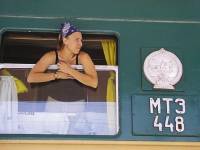 A girl leaning out the window of a Tranas-Siberian train