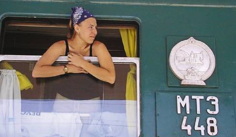 A girl leaning out the window of a Tranas-Siberian train