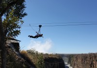 A happy customer on a zip line at Victoria Falls
