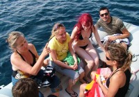 On the go passengers travelling to the shore in a Zodiac boat