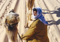 An Egyptian man on a camel in the desert