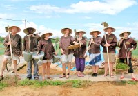An On The Go Vietnam Tour Group get involved working on the farm