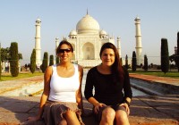 Two girls sitting in front of the marvellous Taj Mahal in Agra