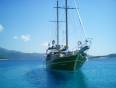 A gulet boat sails across the blue sea