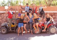 An on the go tour group after an exhilarating quad bike ride