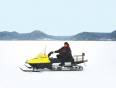 Man riding a snow mobile on the frozen expanse of Lake Baikal