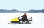 Man riding a snow mobile on the frozen expanse of Lake Baikal