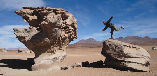 An On The Go passenger makes the most of the amzing rocks found on South America Tours