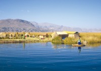 A peruvian lady on a boat next to Uros Island on Lake Titicaca, where everything is made of Totara r