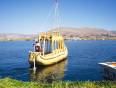 A man sailing a boat made of Totara reed on Lake Titicaca in Peru