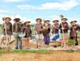A group learning old farming practises in Tra Que on a Vietnam group tour