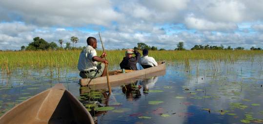 Kick back and relax in a mokoro on your way to the Okavango Delta on an African Safari