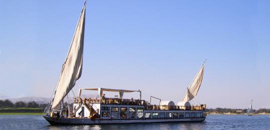 Dahabeya sailing on the Nile across from the West Bank in Egypt