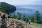 Two people trekking along the shores of Lake Baikal in Siberia