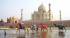 People leading their camels past the Taj Mahal