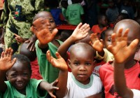 A group of African children wave enthusiastically