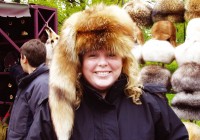A girl tries on a lovely furry Russian hat