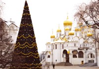 The Cathedral of Assumption in the Kremlin with a big Xmas tree beside it
