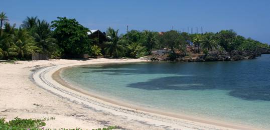 Pristine white sandy bay of Roatan Island in Honduras - relax here on a Central America tour.