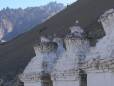 A row of three Tibetan stupas in Alchi. Photo credit Argenberg.