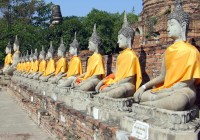 Buddhist sculptures swathed in orange robes in Thailand