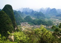 A landscape of karst limestone outcrops, rising from flat rice paddy fields in Guilin