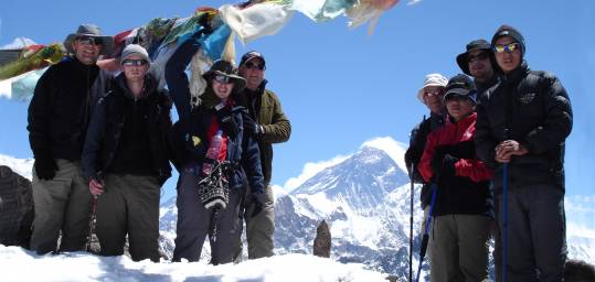 A group of trekkers in Nepal at the summit of Gokyo-Ri in the Himalayas