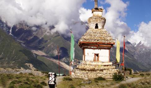 A man trekking to a Buddhist stupa in Nepal