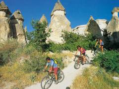 Women taking a bike ride through the surreal landscape of Cappadocia