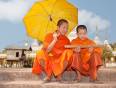 Young Buddhist Laos men in their iconic orange robes.