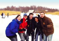 A group of happy on the go passengers posing for a photo in the snow