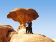 Couple under an unusual rock formation in the White Desert