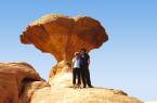 Couple under an unusual rock formation in the White Desert