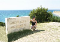 A girl next to the ANZAC Cove sign in Gallipoli