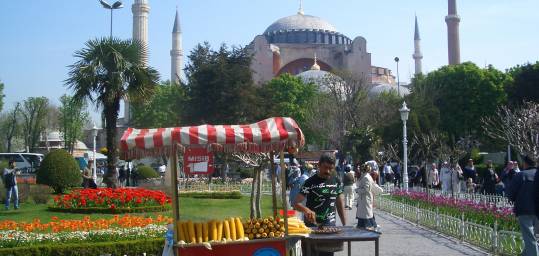 A Turkish man selling sweetcorn from a stall outside Hagia Sofia in Istanbul