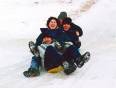A group of on the go travellers enjoying sledding in the snow in Russia