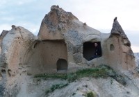 A man sitting in one of the cave dwellings in Cappadocia