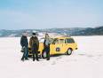 Three people and their car on the frozen expanse of ice on Lake Baikal