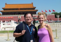 An on the go tour guide and passenger outside the Forbidden City in Tiananmen Square, Beijing