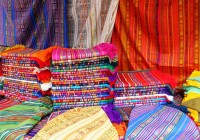 Colourful scarves piled up and ready for sale at Otavalo market