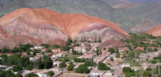 The colourful hills in Argentina surround a village. Visit here on our Argentina tours.
