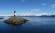 A lighthouse looks out across the water to Argentina's snowy peaks - a must see on our Argentina tou