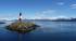 A lighthouse looks out across the water to Argentina's snowy peaks - a must see on our Argentina tou