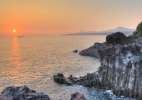Sunsets over the strange lava formations of Jeju Island