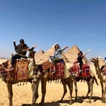 Ladies on camels at the Pyramids of Giza | Egypt | On The Go Tours