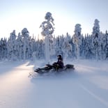 Snowmobiling by the forest | Finland