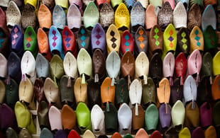 Colourful shoes in a Fes market - Morocco Tours - On The Go Tours