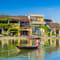 A traditional longboat sails along the river in Hoi An