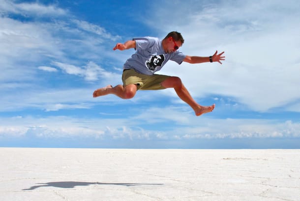 Man jumping over salt flats in Bolivia - South America Tours - On The Go Tours